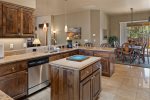 The gourmet kitchen is a chef`s delight with a view from the kitchen of the open floor plan